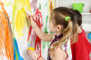 preschool age girl finger painting